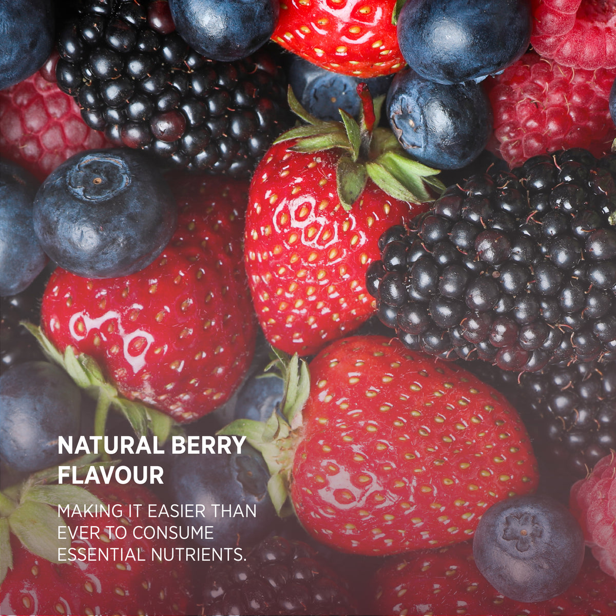 Close-up of fresh strawberries, blueberries, blackberries, and raspberries. Text: 'NATURAL BERRY FLAVOUR MAKING IT EASIER THAN EVER TO CONSUME ESSENTIAL NUTRIENTS.'