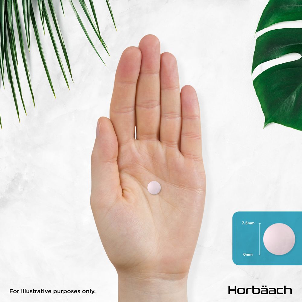 Light pink, round tablet 7.5mm in diameter and 0mm thick, held in an open hand.