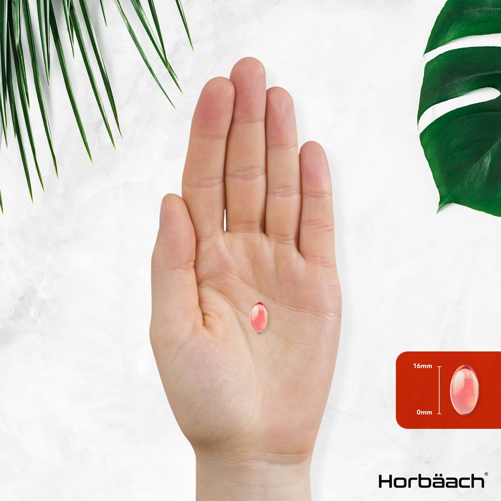 A single 16mm softgel displayed on an open hand.