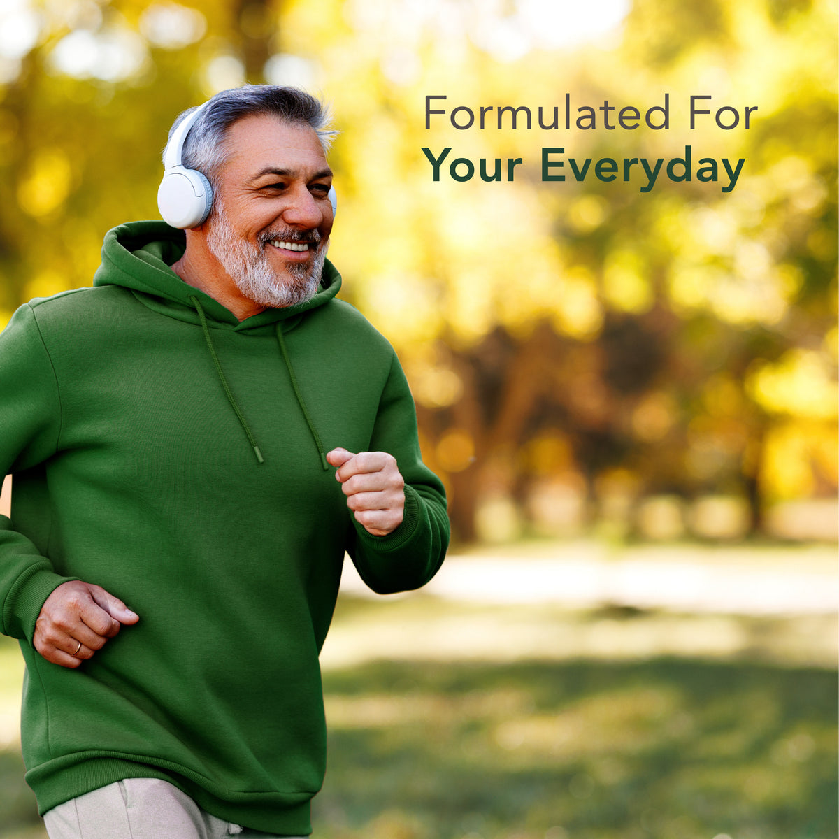Smiling middle-aged man jogging outside with white headphones, promoting Green Lipped Mussel benefits.