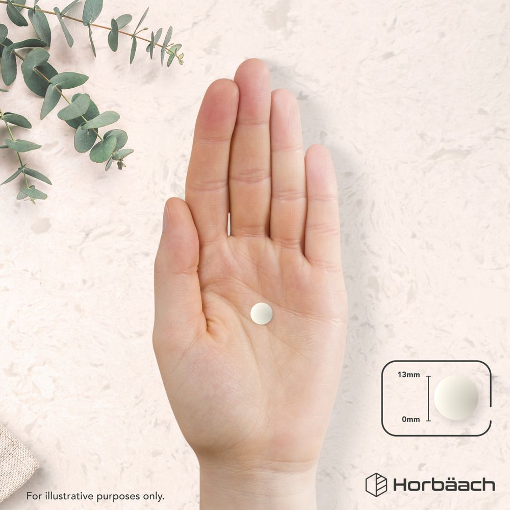 A 13mm round tablet, 0mm thick, is held in a hand.