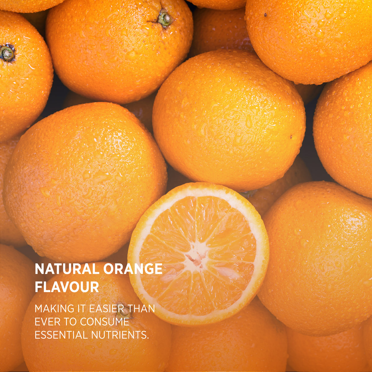 Fresh oranges, one cut in half, with water droplets and text: 'NATURAL ORANGE FLAVOUR. Easier to consume essential nutrients.'