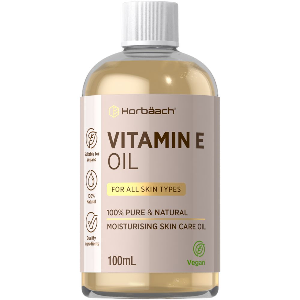 Horbäach Vitamin E Oil 100mL liquid bottle shown in hand for scale.