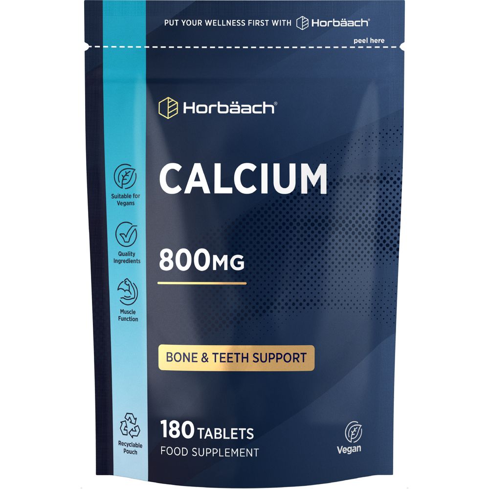 A hand holds a bulk-scale bottle of Vegan Calcium 800mg tablets, 180 count, ideal for those seeking a plant-based calcium supplement.