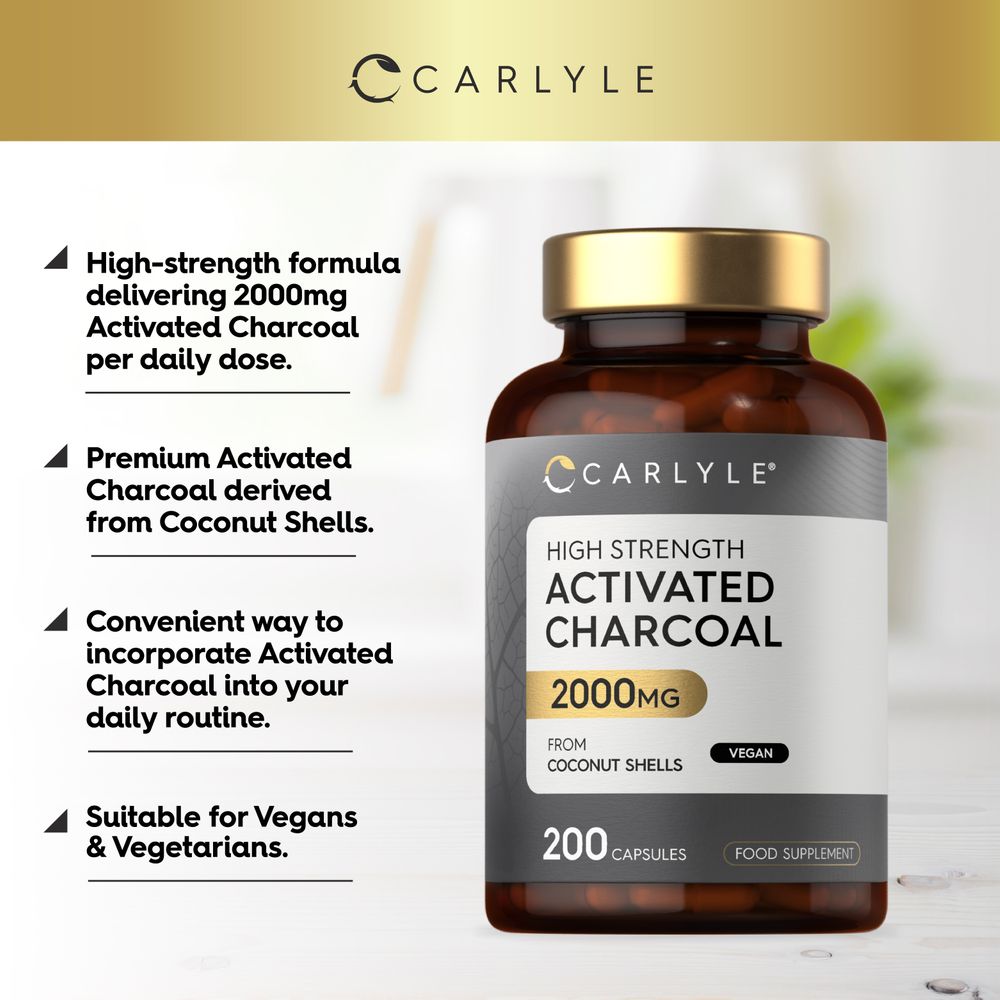 Hand holding a bottle of Activated Charcoal capsules, 2000mg, 200 count, for detox and wellness support.
