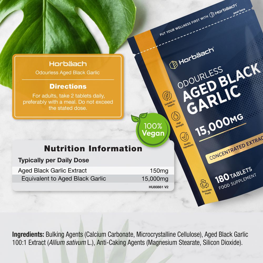 Aged black garlic tablets with 15,000mg equivalent dosage, shown for scale next to a hand.
