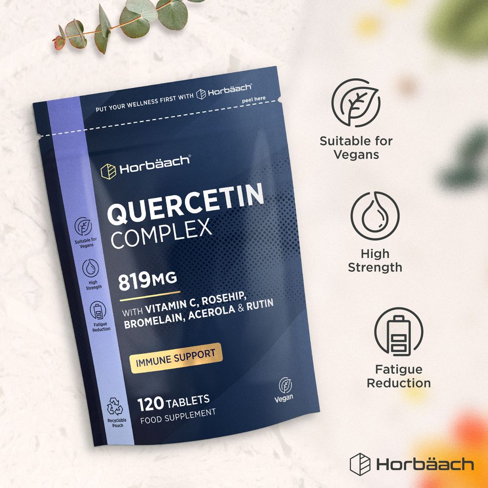 A hand holds a bottle of Quercetin Complex 819mg with 120 tablets, showcasing the supplement's packaging and contents.