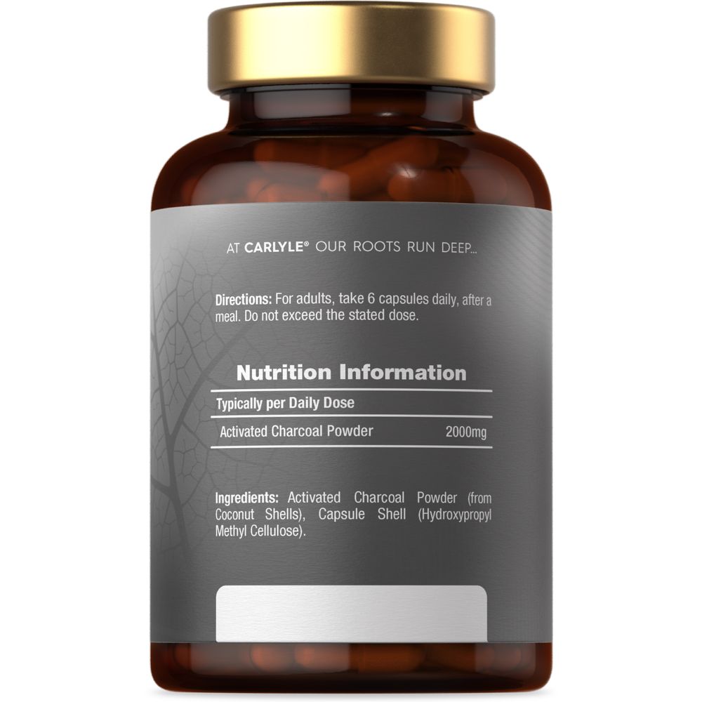 Hand holding a scale with a bottle of Activated Charcoal 2000mg capsules, highlighting the supplement's content and dosage.
