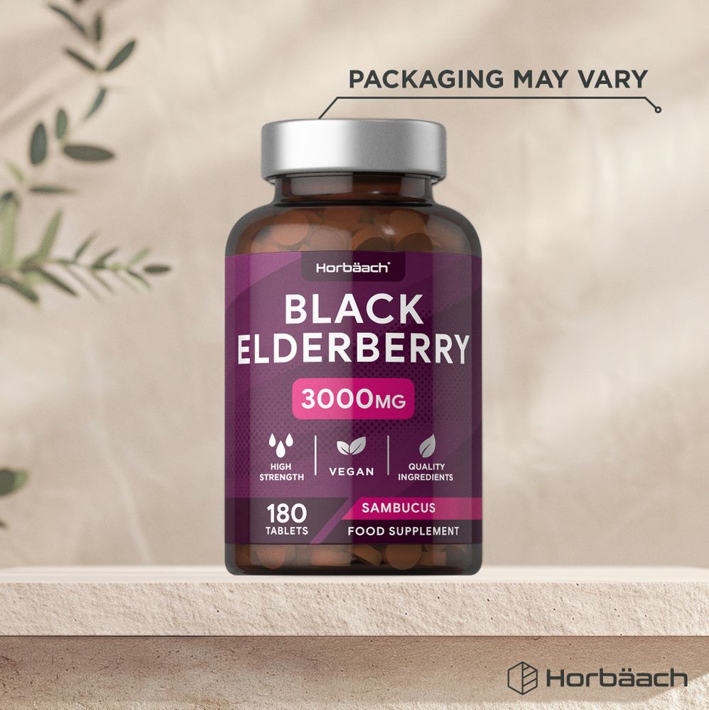 A hand holding a bottle of Horbäach Black Elderberry 3000mg, containing 180 tablets.