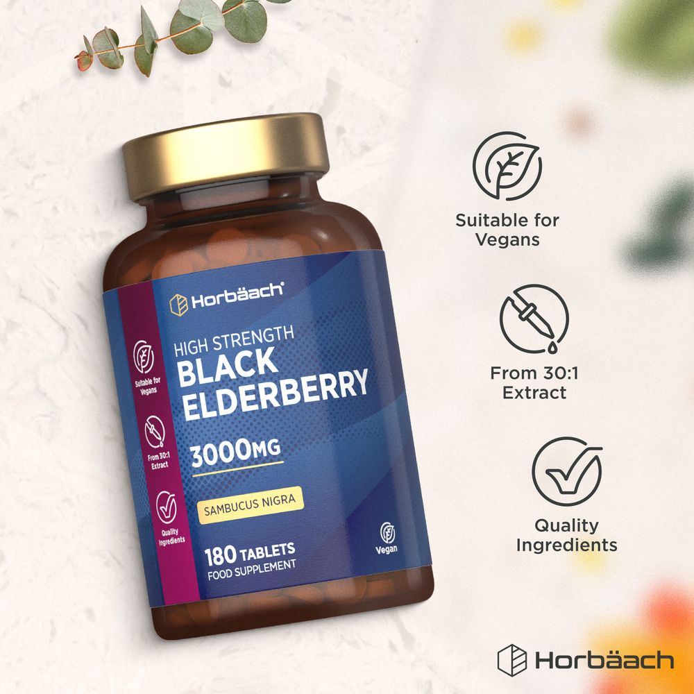 Hand holding a bottle of HU Black Elderberry, 3000mg with 180 tablets, on a bulk scale for weight measurement.