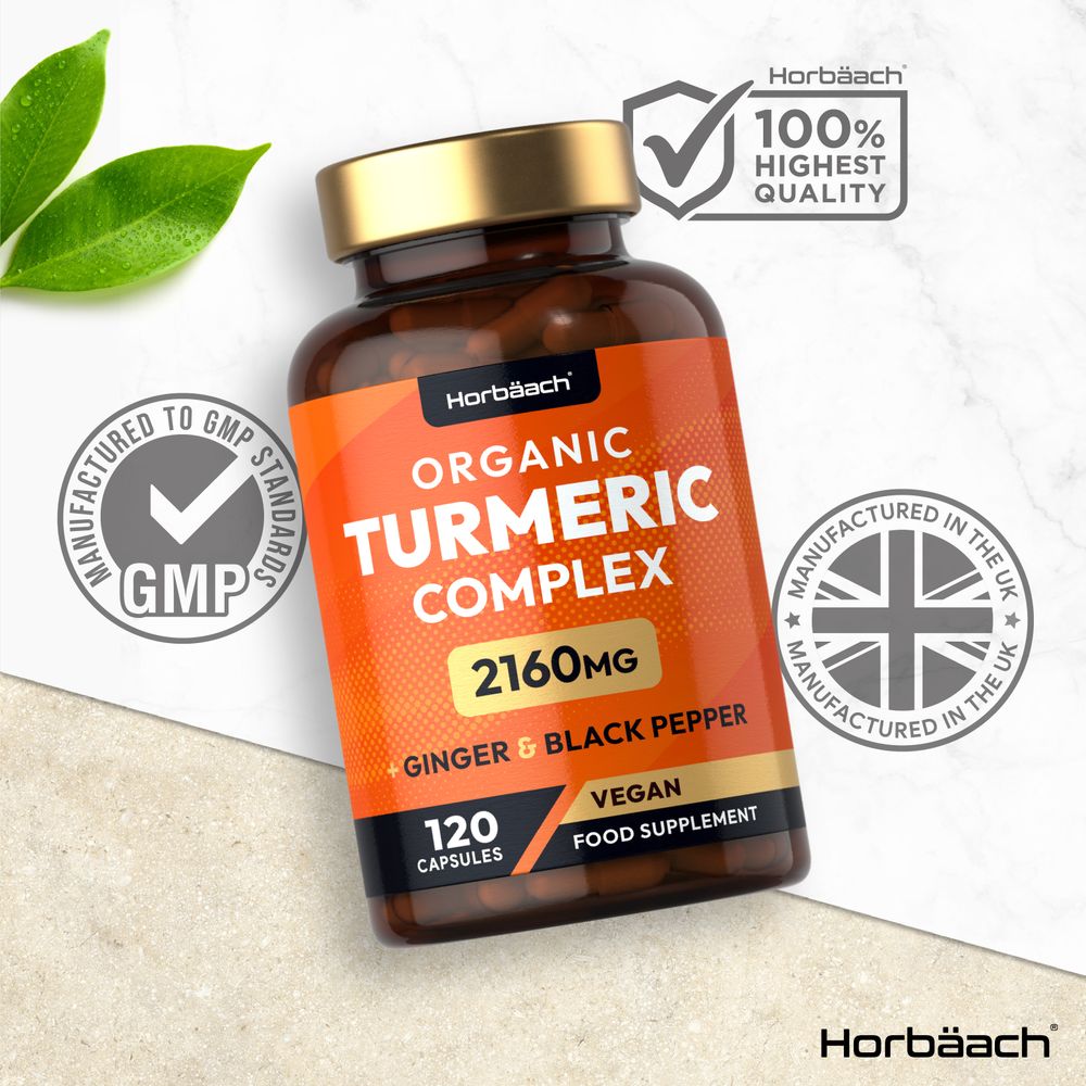 Horbäach Organic Turmeric Complex 2160MG, available in 120 vegan capsules, shown on a hand scale for size reference.