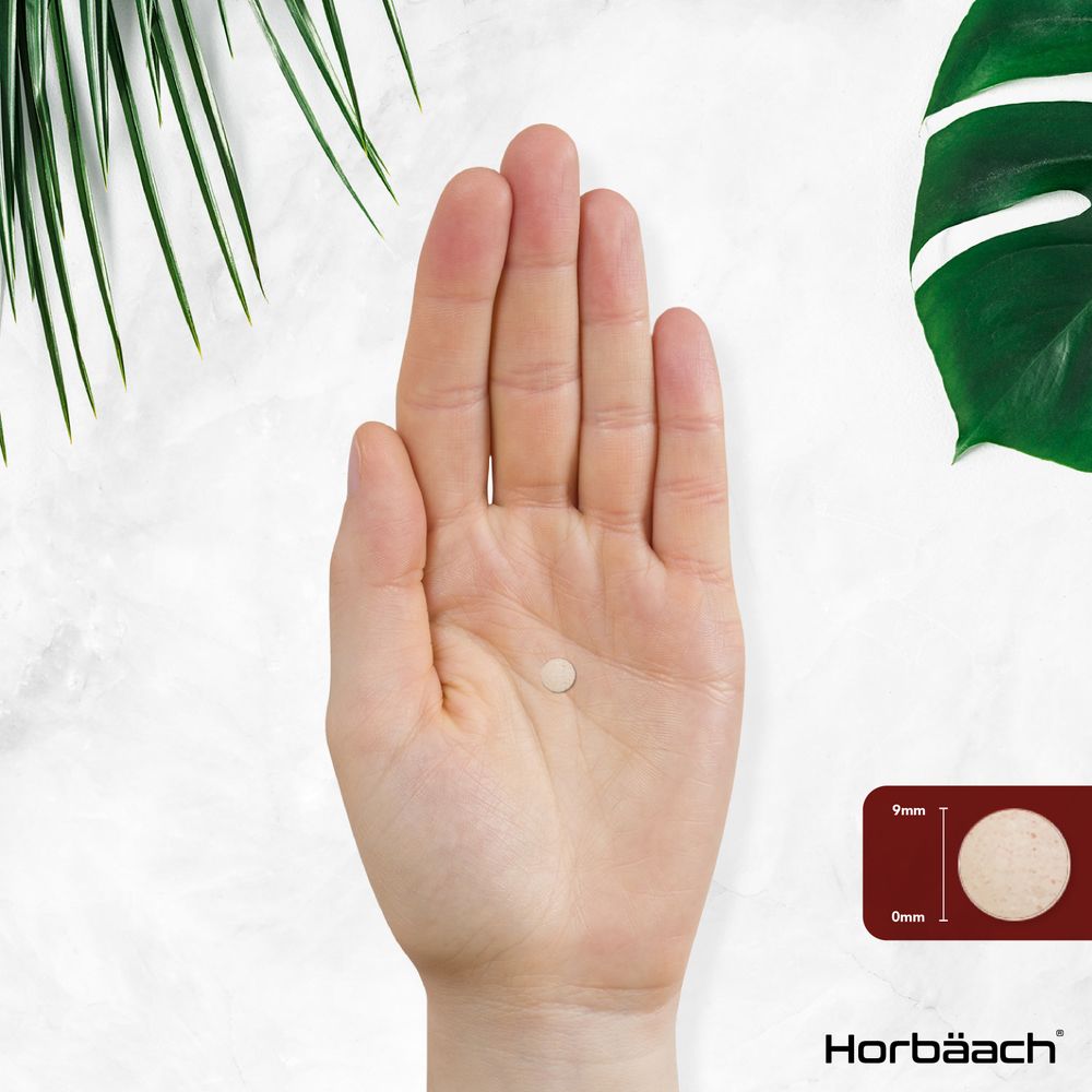 Hand holds a small 9mm diameter, 0mm thickness tablet.