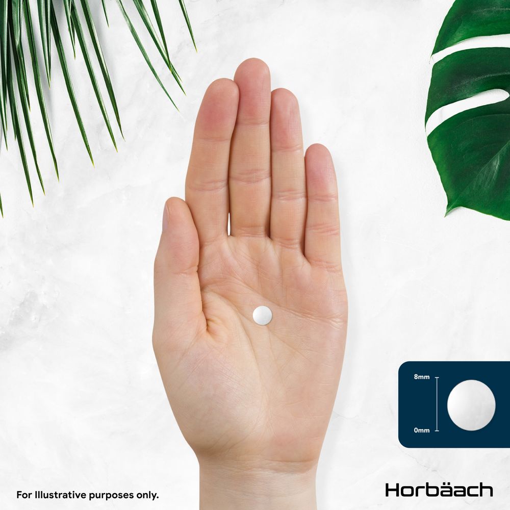 A white round tablet, 8mm in diameter and 0mm thick, rests on the palm of a hand.