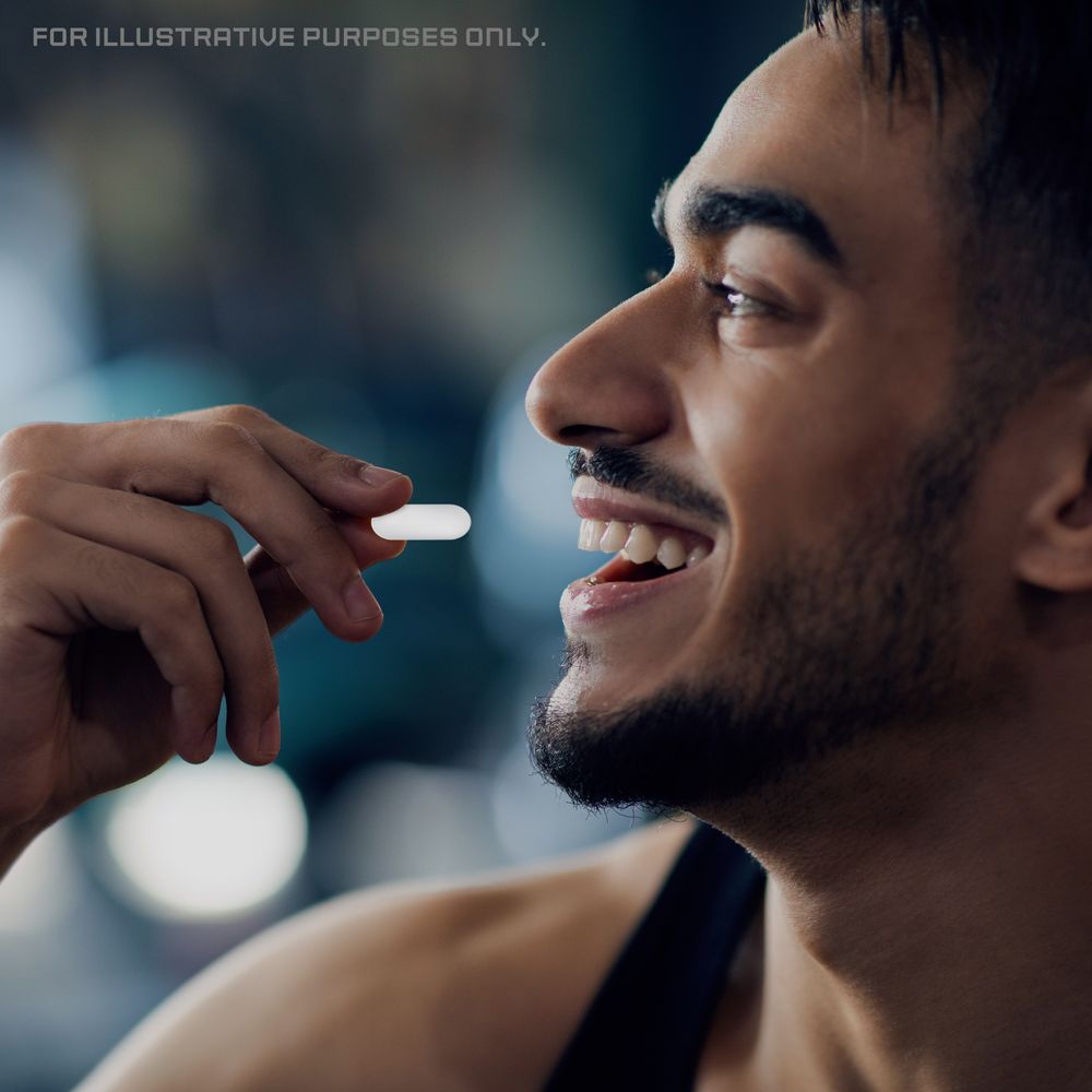 A hand holding a white CF BCAA 2000mg vegan tablet.