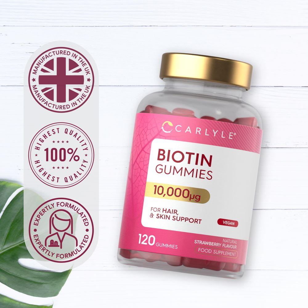 Bottle of Carlyle Biotin 10,000µg, 120 vegan gummies, natural strawberry flavor, on a hand scale.