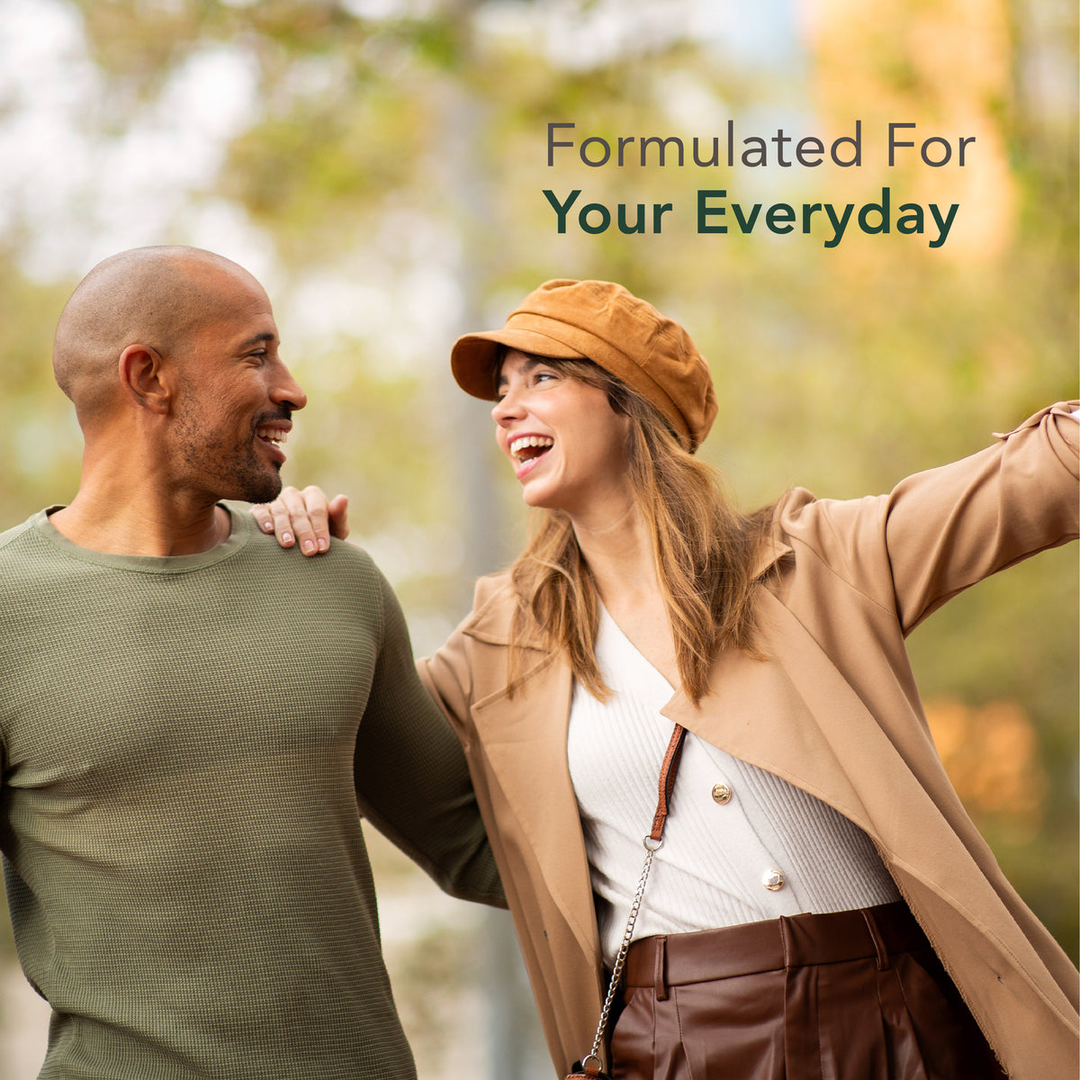 A smiling man and laughing woman outdoors with the text 'Formulated For Your Everyday' visible.