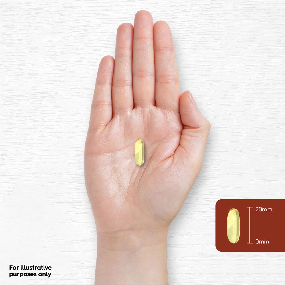 A yellow Vitamin E softgel rests on a hand, with a graphic indicating its length as 20mm.