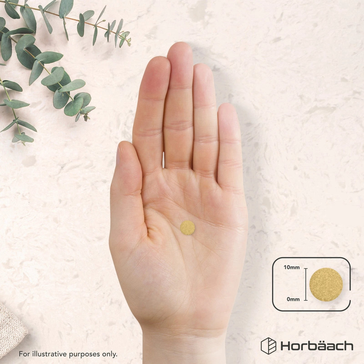 A hand holds a single round 10mm tablet.
