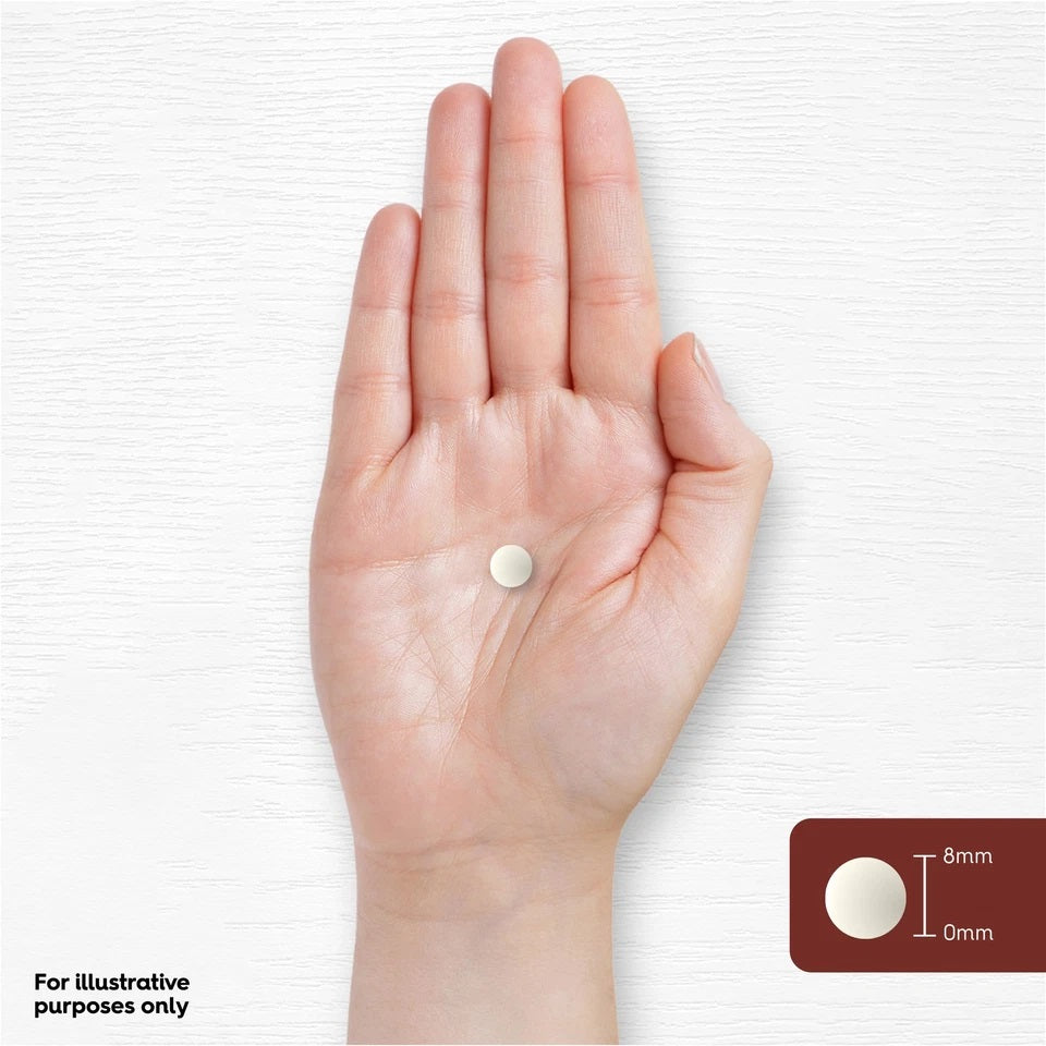 A single white tablet rests on a hand, with an inset indicating its dimensions as 8mm by 0mm.